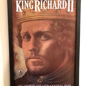 May include: Framed poster for the play "King Richard II" featuring a portrait of a man wearing a crown. The poster includes the text "Joseph Papp Presents" and details about the Delacorte Theater in Central Park, summer 1987.