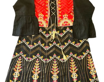 May include: A black dress with a red embroidered jacket. The dress has a chevron pattern and gold embroidery. The jacket has a lace-up front and red and gold embroidery.