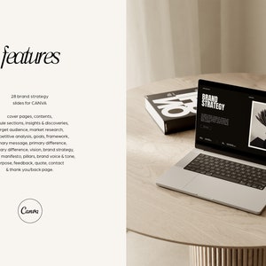 May include: A laptop computer displaying a website with the text "BRAND STRATEGY" on a wooden table. The laptop is open and the screen is showing a website with a black and white photo of a plant. The laptop is surrounded by a wooden table and a book.