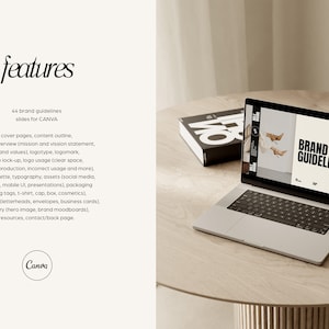 May include: A laptop computer displaying a webpage with the text "Brand Guidelines" on a light brown wooden table. A black book is also on the table.