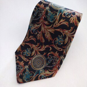 May include: A black silk tie with a gold, teal, and red floral pattern. The pattern features intricate designs of leaves, flowers, and swirls.