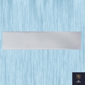 May include: A rectangular, silver-colored metal bar. The bar has a textured surface and is set against a light blue background with a vertical, water-like pattern. The bottom right corner features a logo with a crest and the text "ARIH FINDINGS."