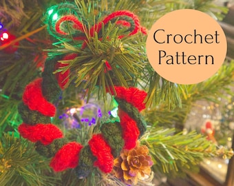May include: A red and green crocheted wreath ornament with a bow hanging on a Christmas tree. The text "Crochet Pattern" is written on a peach-colored circle.