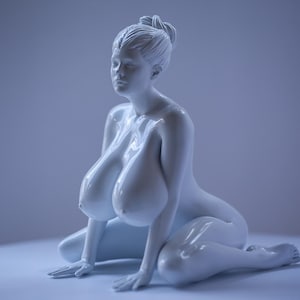 May include: A white, glossy, ceramic sculpture of a woman in a seated pose. The sculpture has a realistic, detailed design.