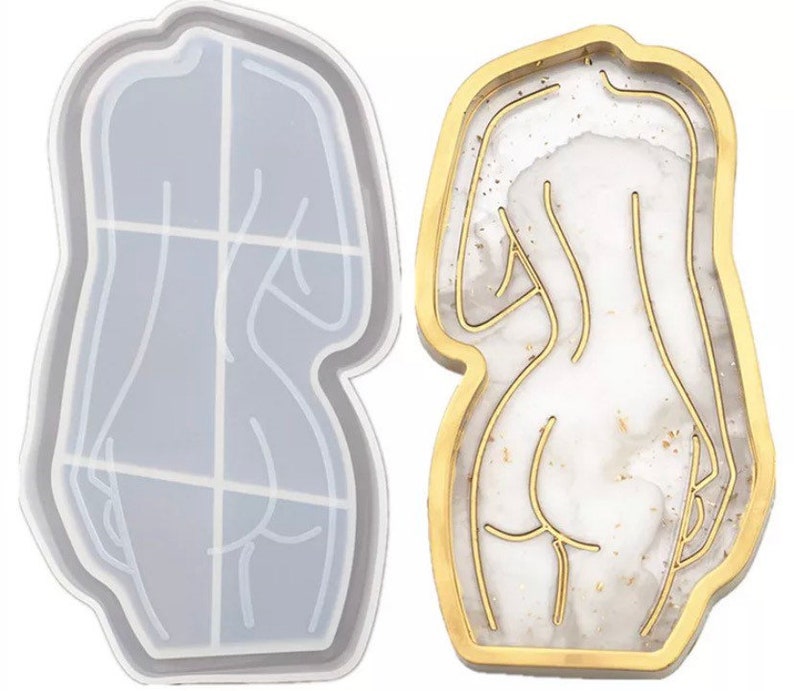 May include: Two decorative trays. One is a clear, body-shaped mold with grid lines. The other is a gold-edged tray with a white and gold marbled design, featuring a gold outline of a body. Both are in a body shape.
