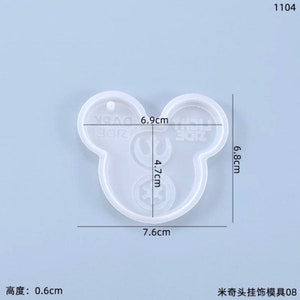 May include: A clear, Mickey Mouse-shaped silicone mold for crafting. The mold measures 7.6 cm wide, 6.8 cm high, and 0.6 cm thick. The design includes the text "ZIDE" and other graphic elements.