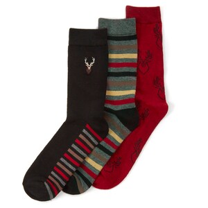 May include: Three pairs of socks with different patterns. One pair is black with a red, white and brown striped pattern on the ankle. Another pair is red with a black and white deer pattern. The last pair is grey with red, white and brown stripes.