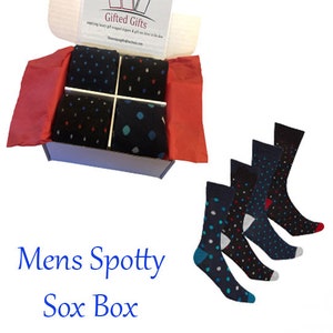 May include: A gift box filled with colourful polka dot socks. The box is white with the words "Gifted Gifts" printed on the top. The socks are arranged in the box in four pairs, each pair with a different colour scheme. The socks are all made of a soft, comfortable material.