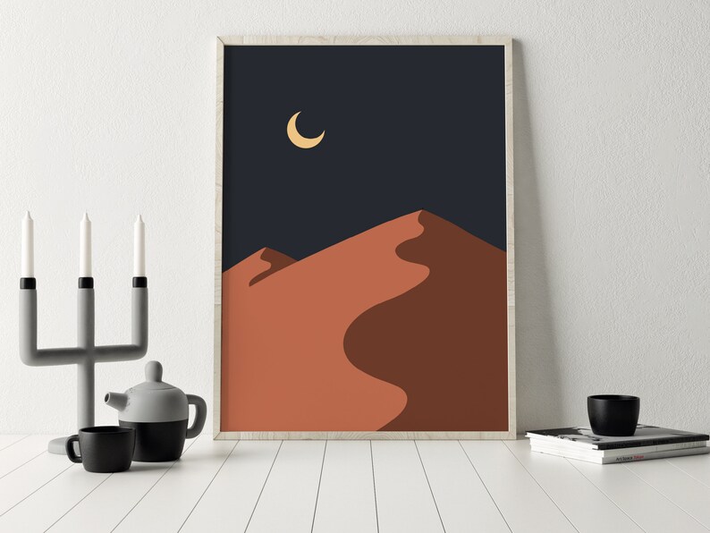 May include: Abstract art print featuring a crescent moon in a dark blue sky above a single orange sand dune.