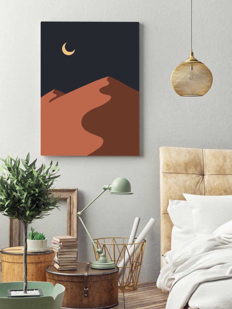 May include: A digital art print featuring a minimalist desert landscape with a crescent moon in the night sky. The print has a dark blue background and the sand dunes are a warm orange color.