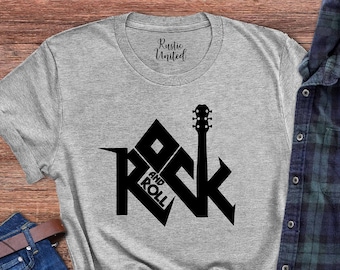 May include: A gray t-shirt with a black graphic of a guitar and the words "Rock and Roll" in a house shape.