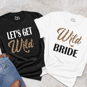 May include: Two white t-shirts with black text and a leopard print design. One shirt says "Let's Get Wild" and the other says "Wild Bride".