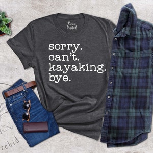 May include: A dark gray t-shirt with the text "sorry. can't. kayaking. bye." printed in white.
