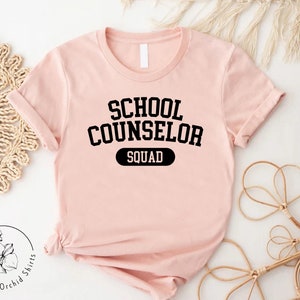 a pink shirt that says school counselor squad