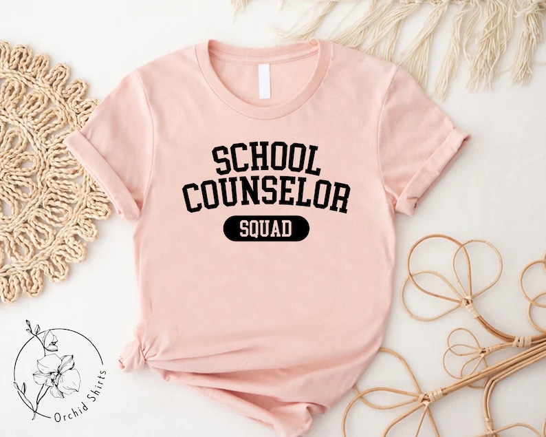 a pink shirt that says school counselor squad