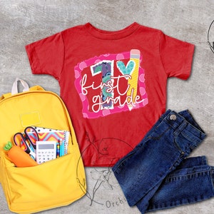 May include: Red t-shirt with a colourful graphic that says "1st grade" with a pencil and heart. A yellow backpack with school supplies, blue jeans, and a white flower.