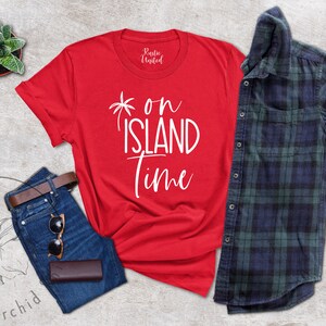 May include: Red t-shirt with white text that says "* on ISLAND time" with a palm tree graphic.