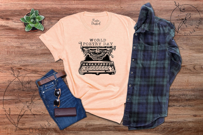 May include: A peach-coloured t-shirt with the text "World Poetry Day" and a vintage typewriter graphic.