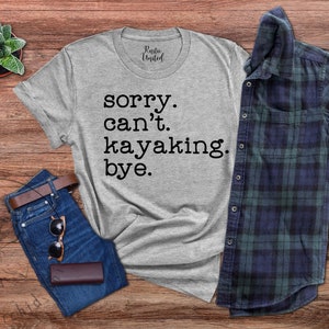 May include: A gray t-shirt with the text "sorry. can't. kayaking. bye." printed in black.