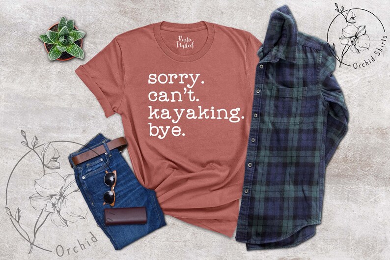 May include: A rust-colored t-shirt with the text "sorry. can't. kayaking. bye." in white lettering.