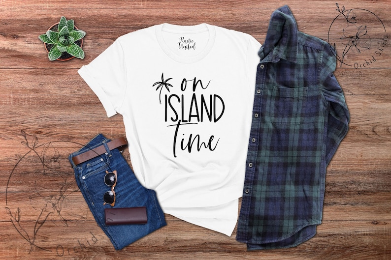 May include: White t-shirt with black text that reads "on island time" and a palm tree graphic.
