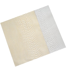 May include: Two pieces of faux snakeskin fabric, one in a light gold color and the other in white.