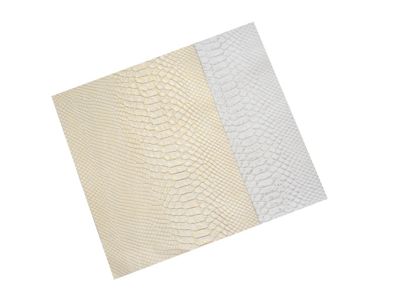 May include: Two pieces of faux snakeskin fabric, one in a light gold color and the other in white.