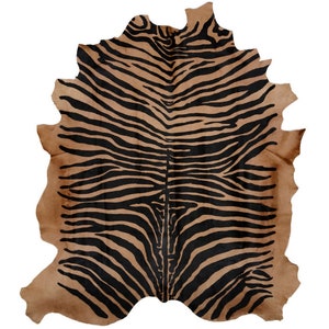 May include: A brown and black zebra-print cowhide rug. The rug has a natural, irregular shape.
