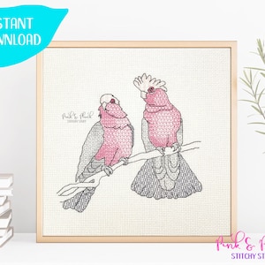 May include: Cross stitch pattern featuring two pink and grey galahs perched on a branch. The pattern is titled "Pink & Pluch" with the text "Stitchy Stuff" below.