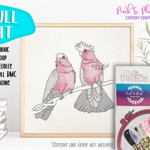 May include: A complete cross-stitch kit featuring two pink and grey cockatoos on a branch. The kit includes fabric, hoop, needles, full DMC skeins, and the text "Pink & Pluch Stitchy Stuff" on the packaging.