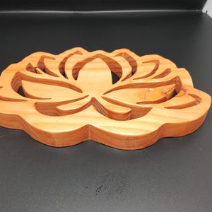 carved wooden trivets in the shape of a lotus