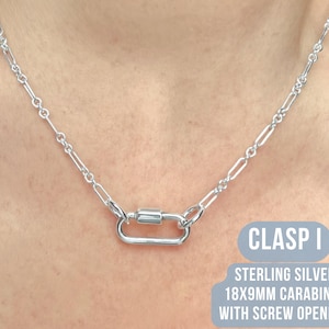May include: A silver necklace with a carabiner clasp. The clasp is 18x9mm and has a screw opening. The necklace is made of sterling silver. The text "CLASP I" is visible in the image.