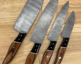 May include: Set of four kitchen knives with wooden handles and Damascus steel blades. The knives are arranged in a row on a wooden surface.