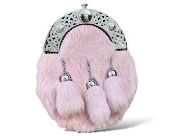 May include: A pink fur sporran with a silver Celtic knot design and three silver tassels.
