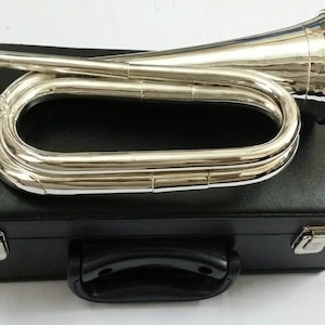 May include: A silver bugle with a black leather case. The bugle has a long, curved mouthpiece and a bell at the end. The case has a handle and a latch.