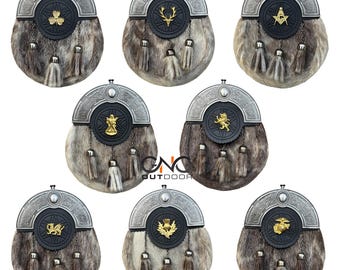 Könnte beinhalten: Eine Sammlung traditioneller schottischer Sporrane. Jeder Sporran hat einen Pelzkörper, einen dekorativen Metallaufsatz und eine Lederverzierung mit einem einzigartigen Emblem. Quasten hängen von unten.