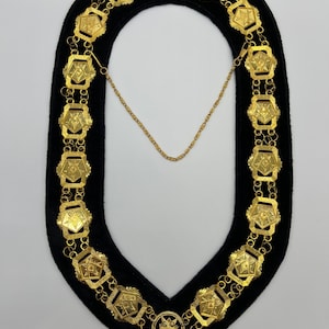 May include: A gold chain with a star-shaped pendant and multiple octagonal links. The chain is displayed on a black velvet background.