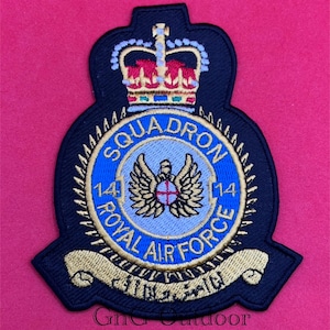 May include: Embroidered patch featuring the Royal Air Force Squadron 14 emblem. The patch has a black border with a blue and gold design, including a crown, wings, and text. The background is a solid red.