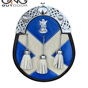 May include: A blue and white leather sporran with a silver chain and three white tassels. The sporran has a silver Celtic knot design and a silver thistle emblem.
