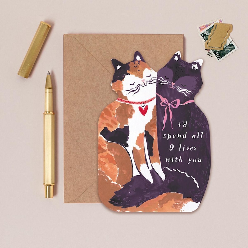 The perfect anniversary card or Valentines card for a cat lover, this uniquely shaped greeting card is cut into the shape of two snuggling cats. The adorable cat cards are blank on the inside, ready for a handwritten romantic message to be added