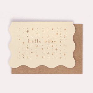 The twinkling pattern of gold foil stars and moons welcomes a unisex new tiny human to the world on this gender neutral new baby card.