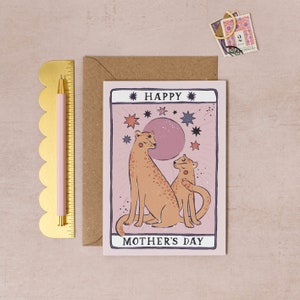 Mothers Day card with tarot card style artwork of leopard mum and little leopard in the style of a tarot card with a pink background and stars.
