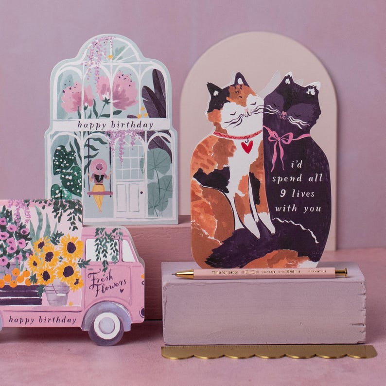 The perfect anniversary card or Valentines card for a cat lover, this uniquely shaped greeting card is cut into the shape of two snuggling cats. The adorable cat cards are blank on the inside, ready for a handwritten romantic message to be added