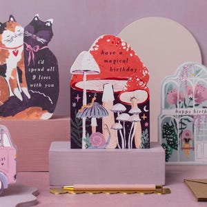 This mushroom birthday card is cut into the shape of mushrooms in a glittering night sky with mystical bugs and stars around. The perfect magical mushroom birthday card for a witch or whimsigoth.
