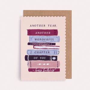 A booktok birthday card featuring a stack of colourful novels and the caption another year another wonderful chapter of you plus a brown recycled kraft envelope.