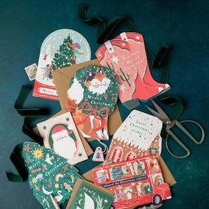 A jolly holiday scene is enclosed in a snowglobe on this uniquely shaped Christmas greeting card, inspired by the beautiful memories we make when spending time with loved ones every year. Trimming the tree, building snowmen, and enjoying the festivities together - there's no doubt that makes for a Merry Christmas. This illustrated Christmas greeting card from UK based brand Sister Paper Co is part of a collection of cards featuring unique shapes and intricate hand-painted designs.
