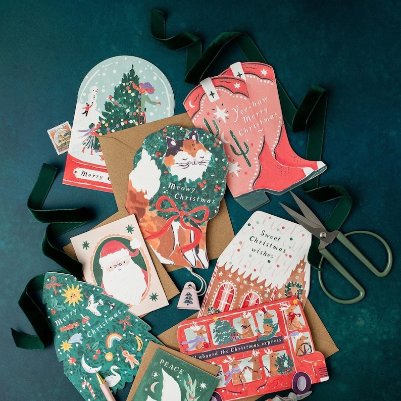 A jolly holiday scene is enclosed in a snowglobe on this uniquely shaped Christmas greeting card, inspired by the beautiful memories we make when spending time with loved ones every year. Trimming the tree, building snowmen, and enjoying the festivities together - there's no doubt that makes for a Merry Christmas. This illustrated Christmas greeting card from UK based brand Sister Paper Co is part of a collection of cards featuring unique shapes and intricate hand-painted designs.