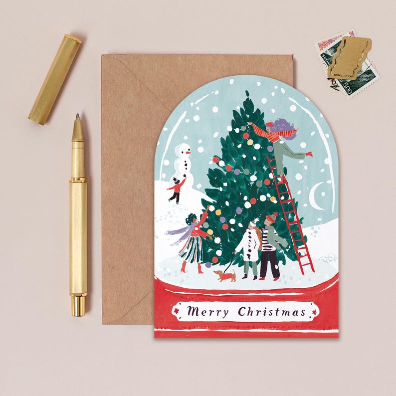 A jolly holiday scene is enclosed in a snowglobe on this uniquely shaped Christmas greeting card, inspired by the beautiful memories we make when spending time with loved ones every year. Trimming the tree, building snowmen, and enjoying the festivities together - there's no doubt that makes for a Merry Christmas. This illustrated Christmas greeting card from UK based brand Sister Paper Co is part of a collection of cards featuring unique shapes and intricate hand-painted designs.