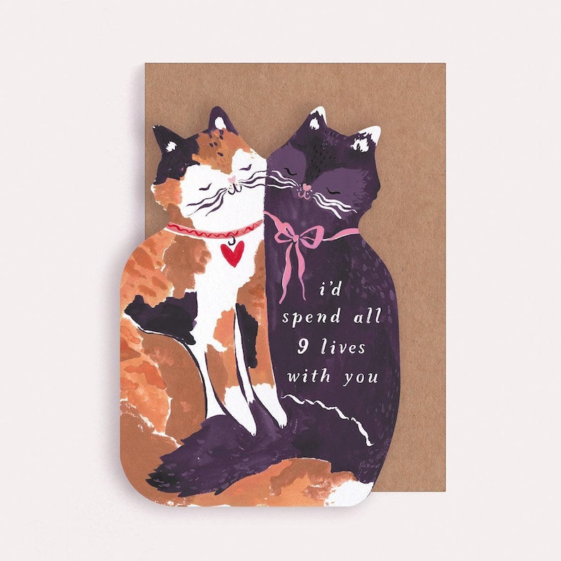 The perfect anniversary card or Valentines card for a cat lover, this uniquely shaped greeting card is cut into the shape of two snuggling cats. The adorable cat cards are blank on the inside, ready for a handwritten romantic message to be added