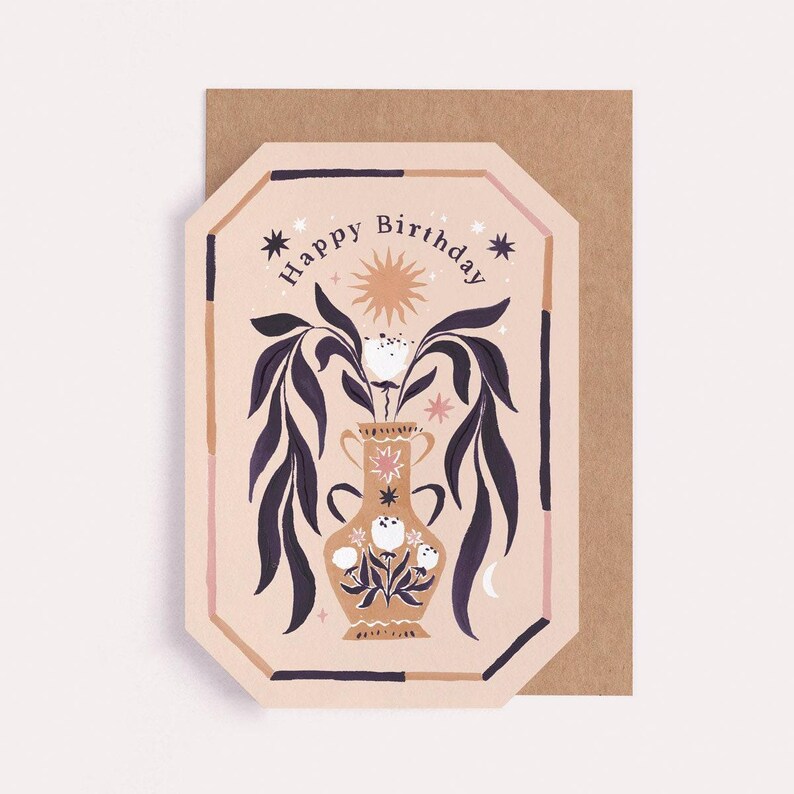 Lush leafy fronds cascade from the decorated vase in the centre of this birthday card, bordered in a coordinating colourful frame that highlights the card’s unique gem shape. The inside of the birthday card is blank, leaving space for a message.